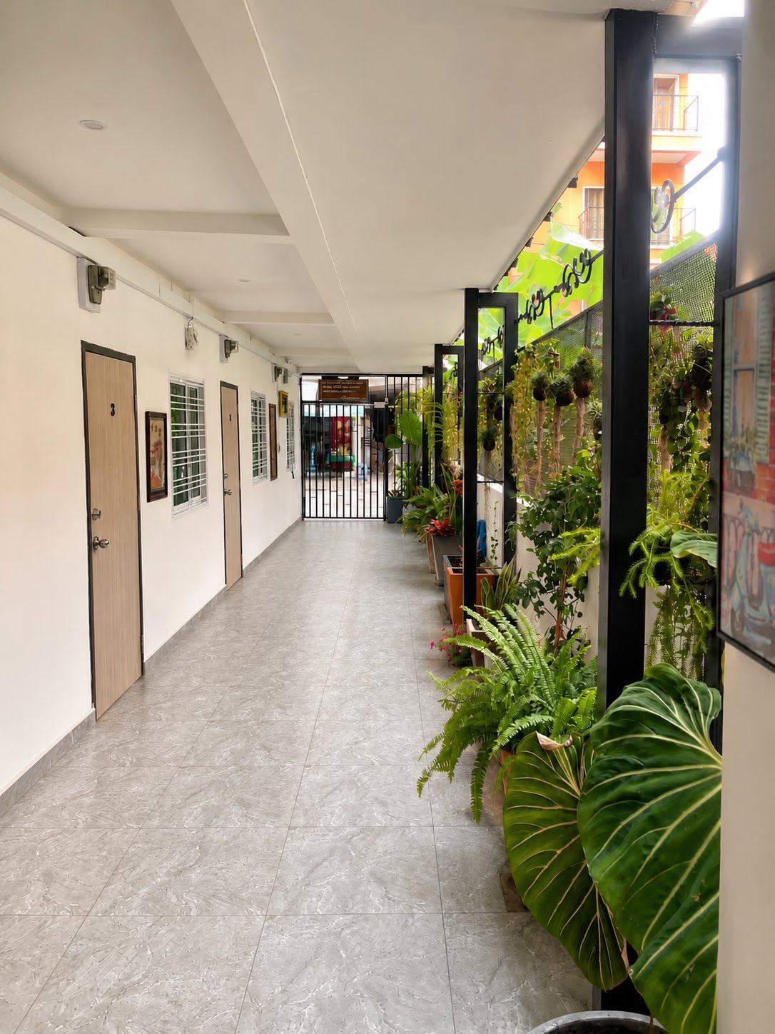 Plant-lined staircase and ground floor corridor at ZZ Boutique Apartment