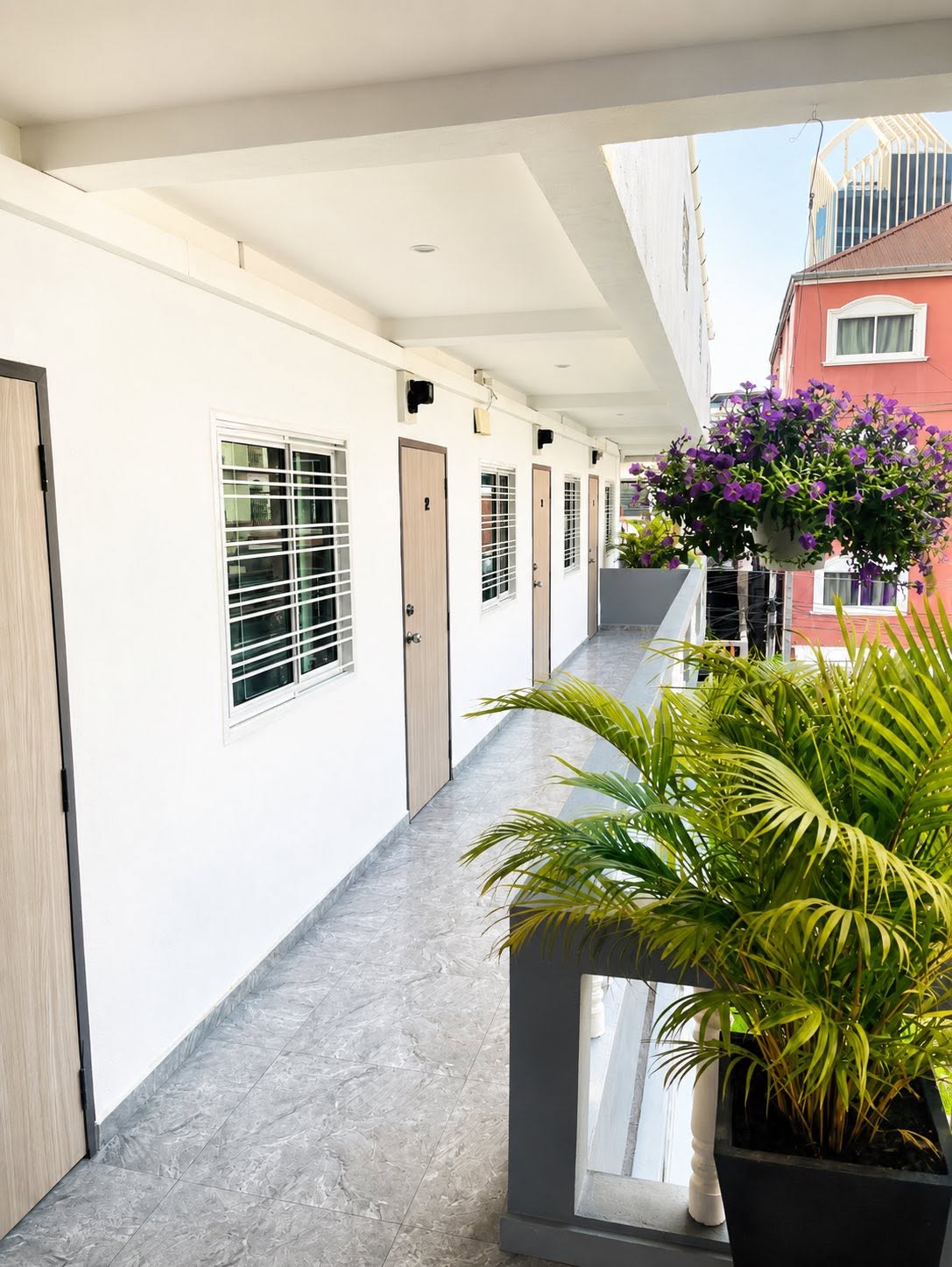 Plant-lined staircase and upper corridor at ZZ Boutique Apartment